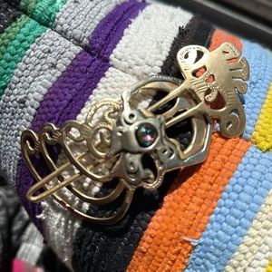 Hair clip made in Cambria. Brass w a beautiful glass foil bead. Brutalist boho